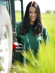 Gwen playfully strips her green shirt matching the green grassy field and poses naughtily all over the jeep, flaunting her awesome physique and gorgeo